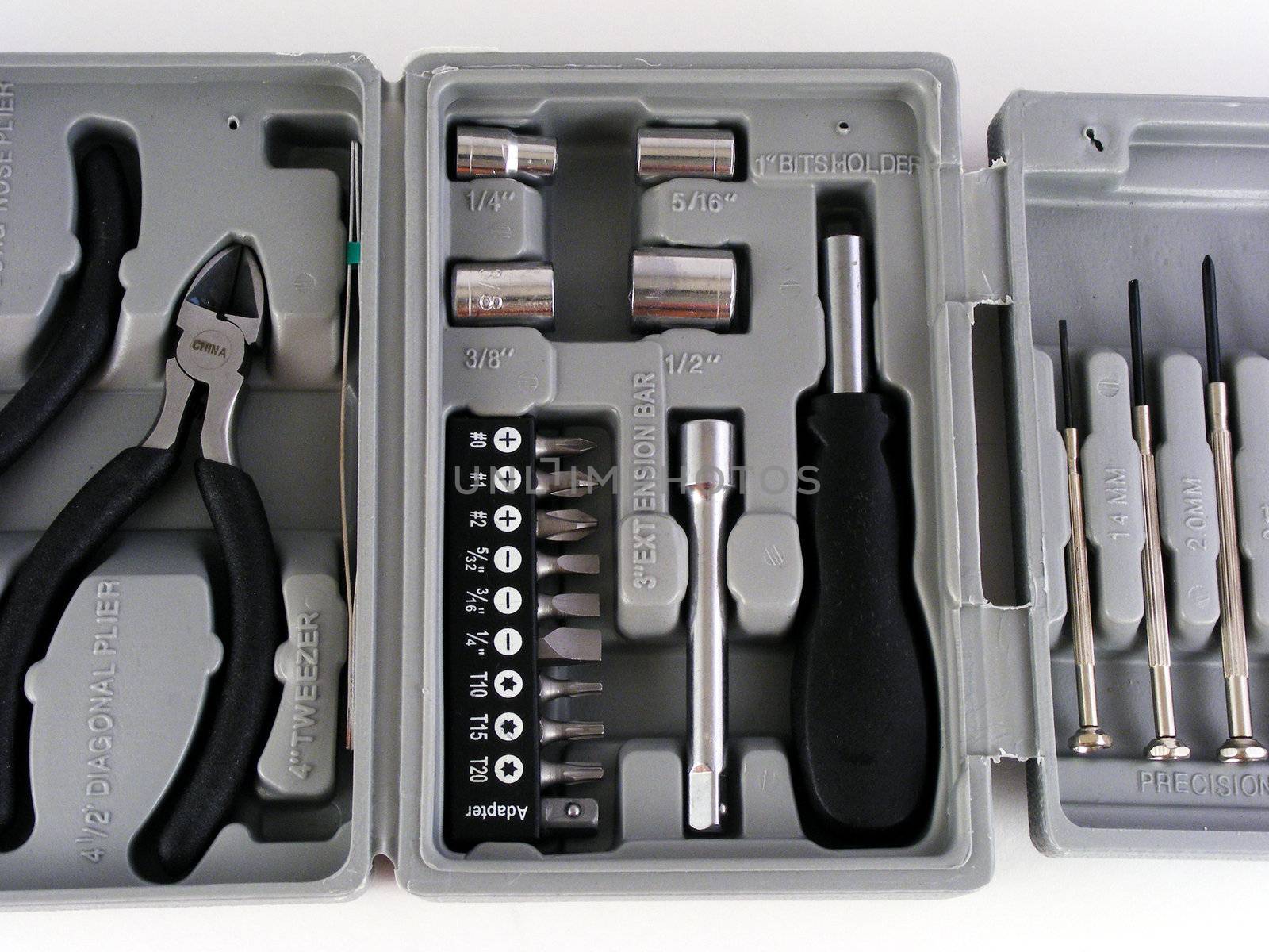 Part of a small toolkit for do it yourself home repairs which includes screwdrivers and pliers.