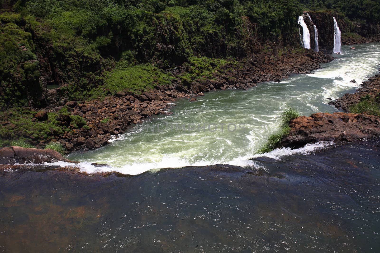 The Iguassu (or Iguazu) Falls is one of the largest masses of fresh water on the planet and divides, in South America, Brazil, Paraguay and Argentina. The waterfall system consists of 275 falls along 2.7 kilometres (1.67 miles) of the Iguazu River. Some of the individual falls are up to 82 metres (269 feet) in height, though the majority are about 64 metres (210 feet).