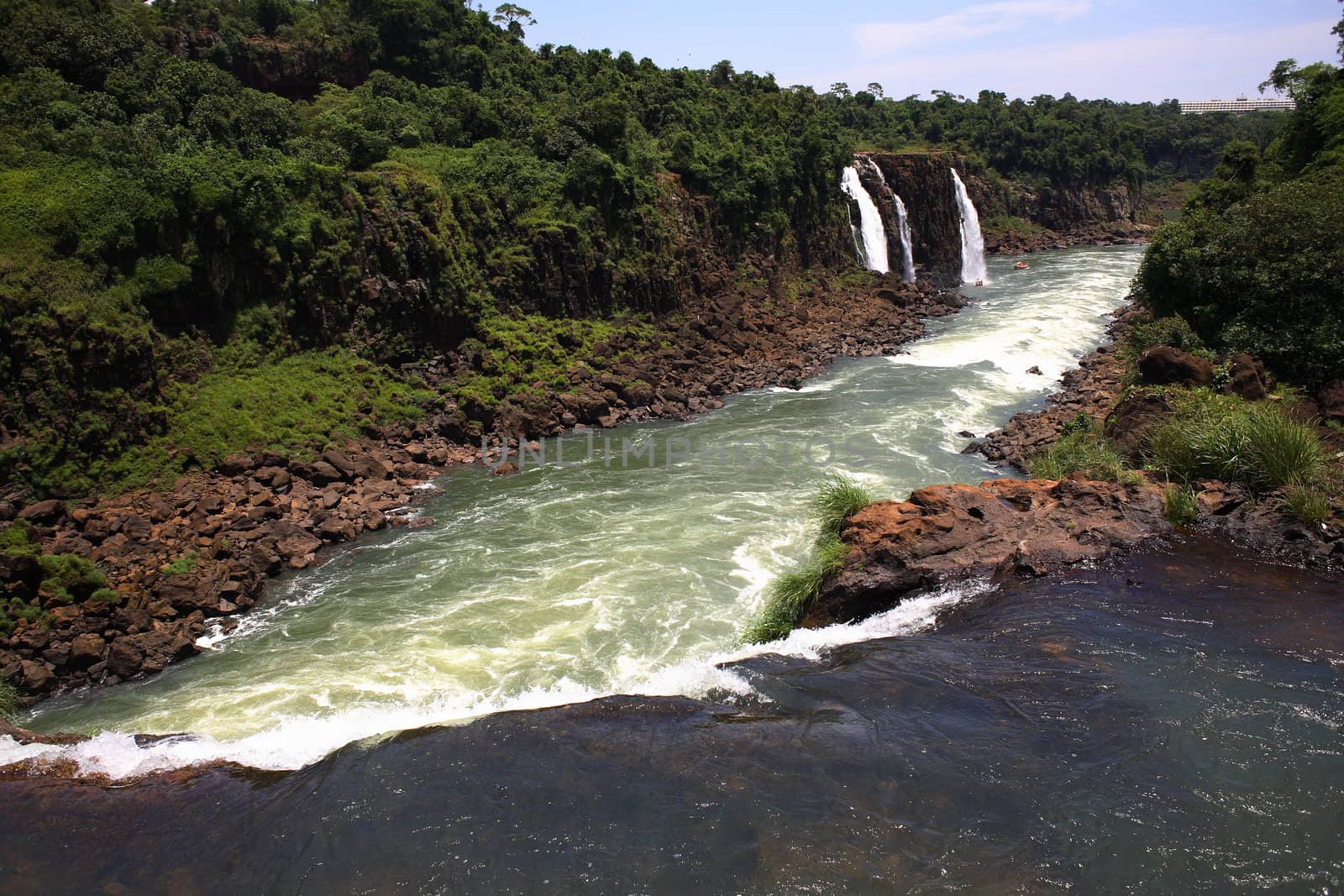 The Iguassu (or Iguazu) Falls is one of the largest masses of fresh water on the planet and divides, in South America, Brazil, Paraguay and Argentina. The waterfall system consists of 275 falls along 2.7 kilometres (1.67 miles) of the Iguazu River. Some of the individual falls are up to 82 metres (269 feet) in height, though the majority are about 64 metres (210 feet).