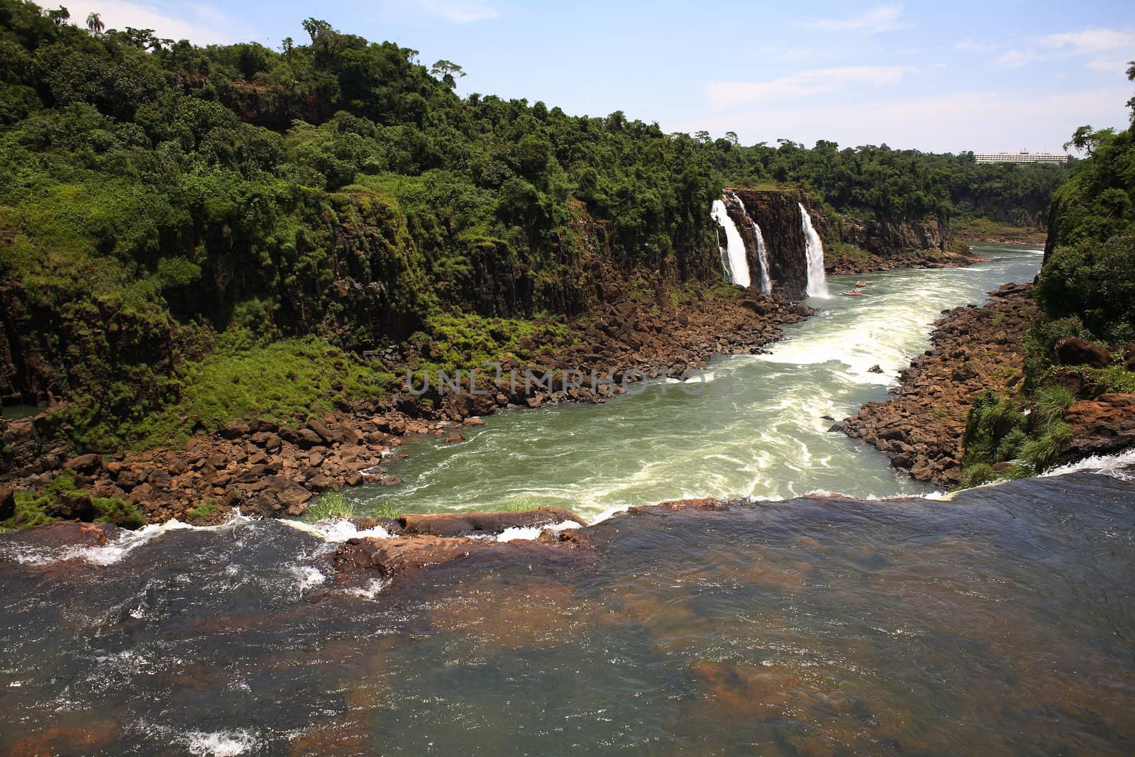 The Iguassu (or Iguazu) Falls is one of the largest masses of fresh water on the planet and divides, in South America, Brazil, Paraguay and Argentina. The waterfall system consists of 275 falls along 2.7 kilometres (1.67 miles) of the Iguazu River. Some of the individual falls are up to 82 metres (269 feet) in height, though the majority are about 64 metres (210 feet).