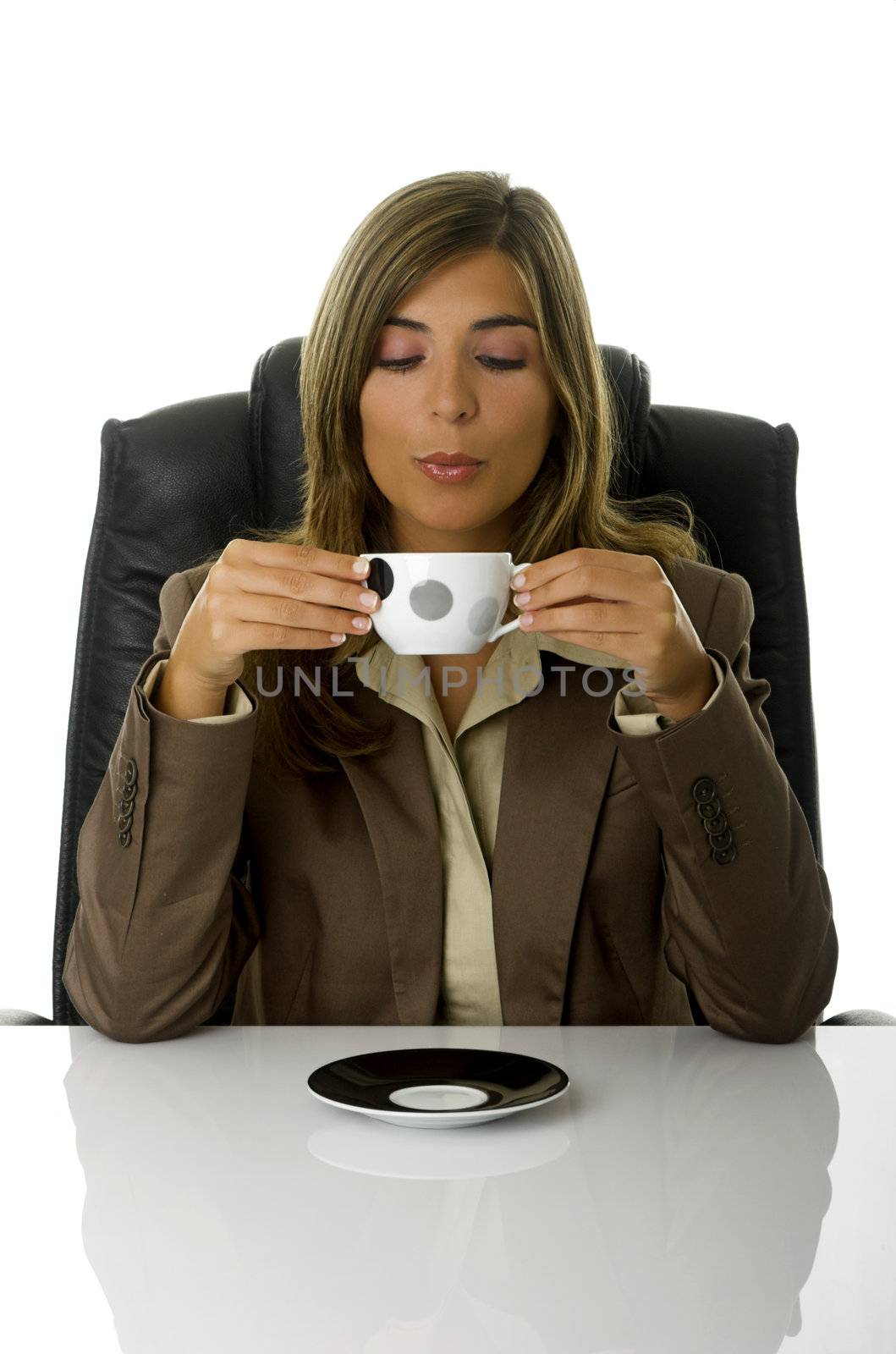 Young and beautiful business woman drinking a coffee in the office