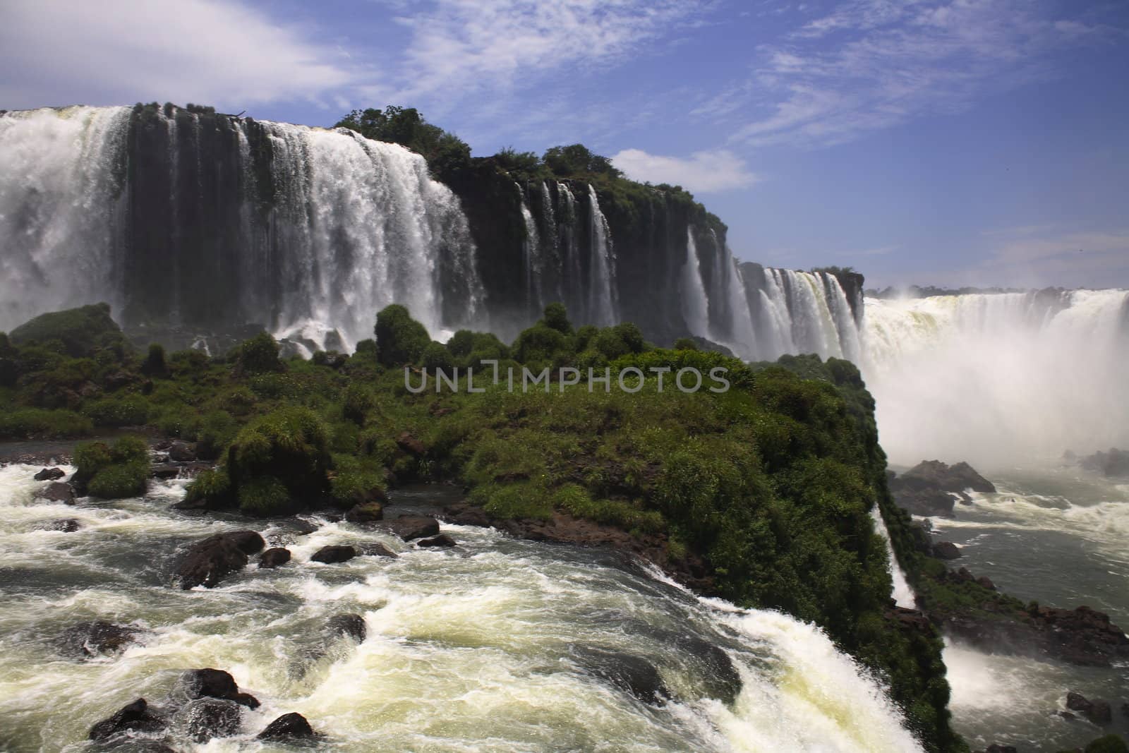 The Iguassu (or Iguazu) Falls is one of the largest masses of fresh water on the planet and divides, in South America, Brazil, Paraguay and Argentina. The waterfall system consists of 275 falls along 2.7 kilometres (1.67 miles) of the Iguazu River. Some of the individual falls are up to 82 metres (269 feet) in height, though the majority are about 64 metres (210 feet).