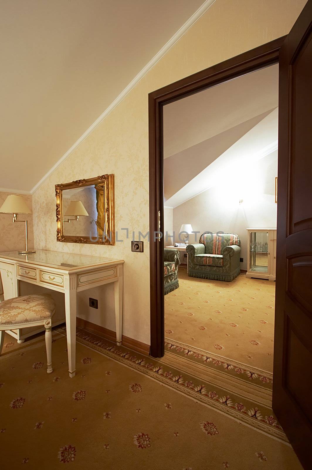 Table, lamp and mirror in rich modern hotel