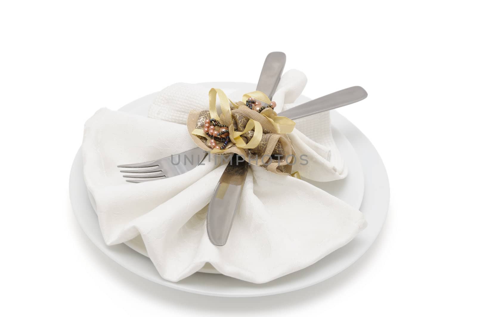 Napkin folded into a "fan " with a knife and fork on white background