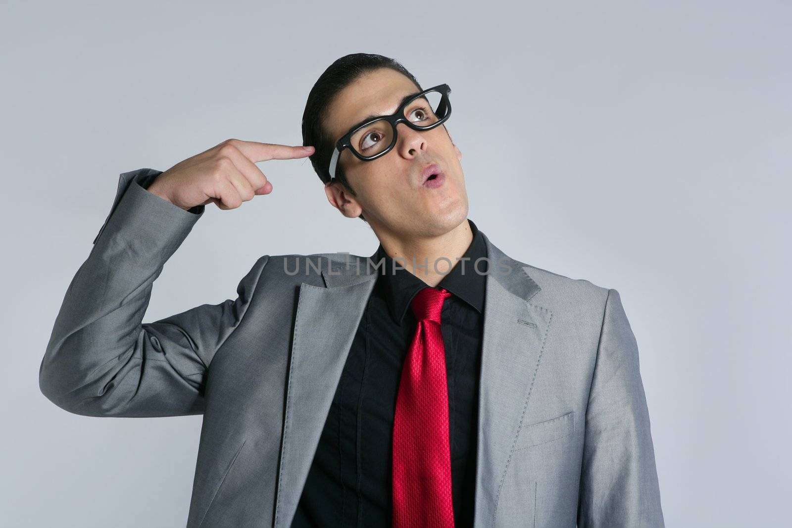 Businessman crazy with funny glasses and suit on gray background