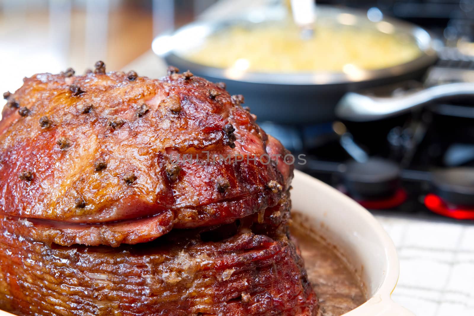 Glazed Spiral Cut Hickory Smoked Ham on Cooking Stove Top