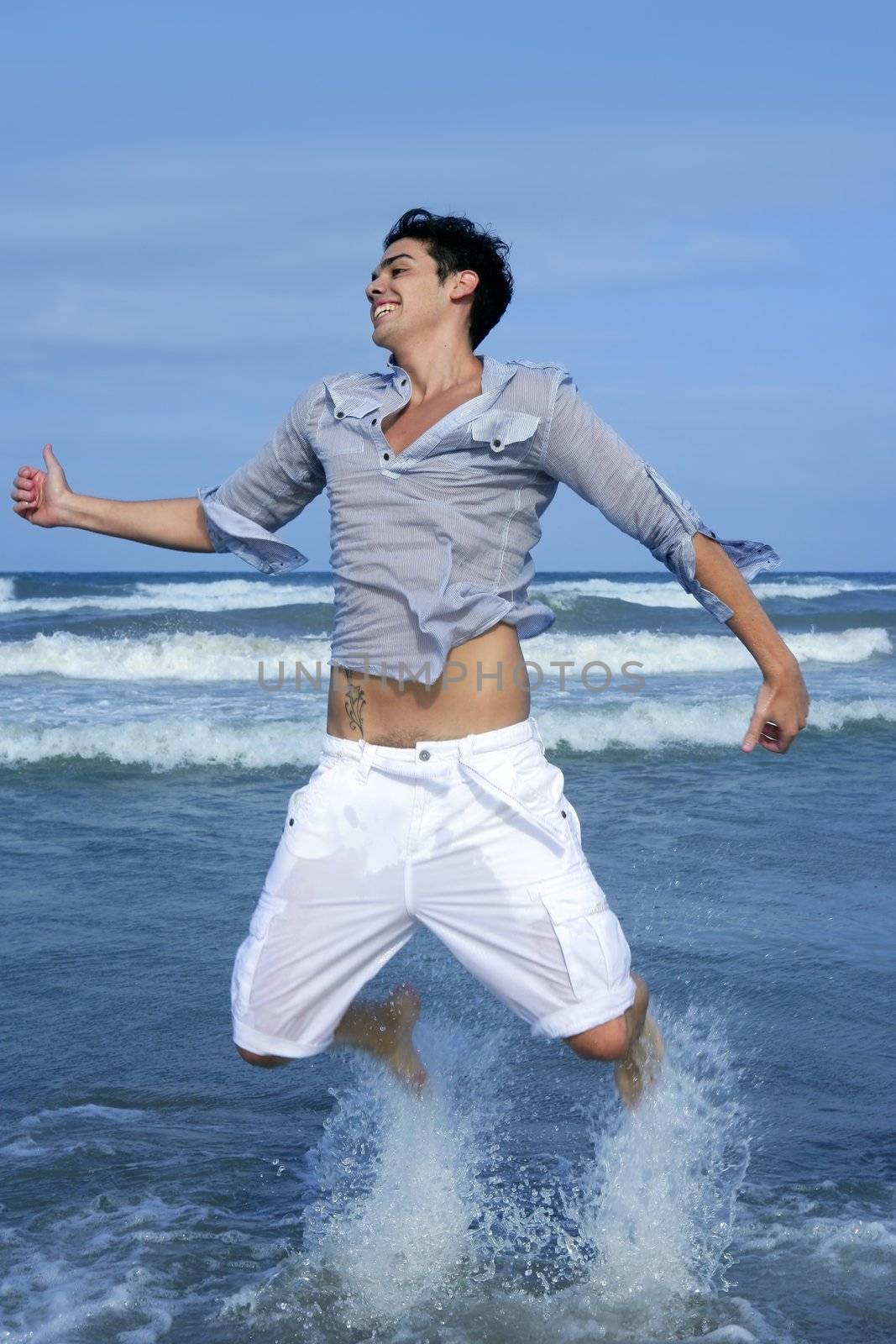 Handsome young man on the blue ocean beach summer sea