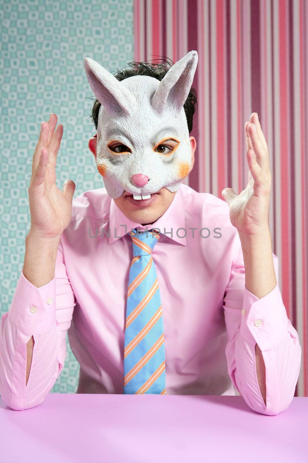Businessman with funny rabbit mask portrait over wallpaper