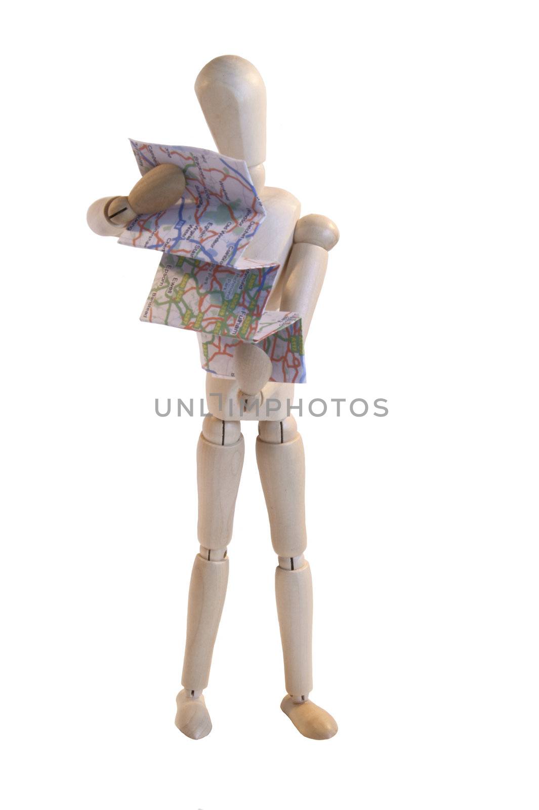 wooden artists dummy in pose as if reading map