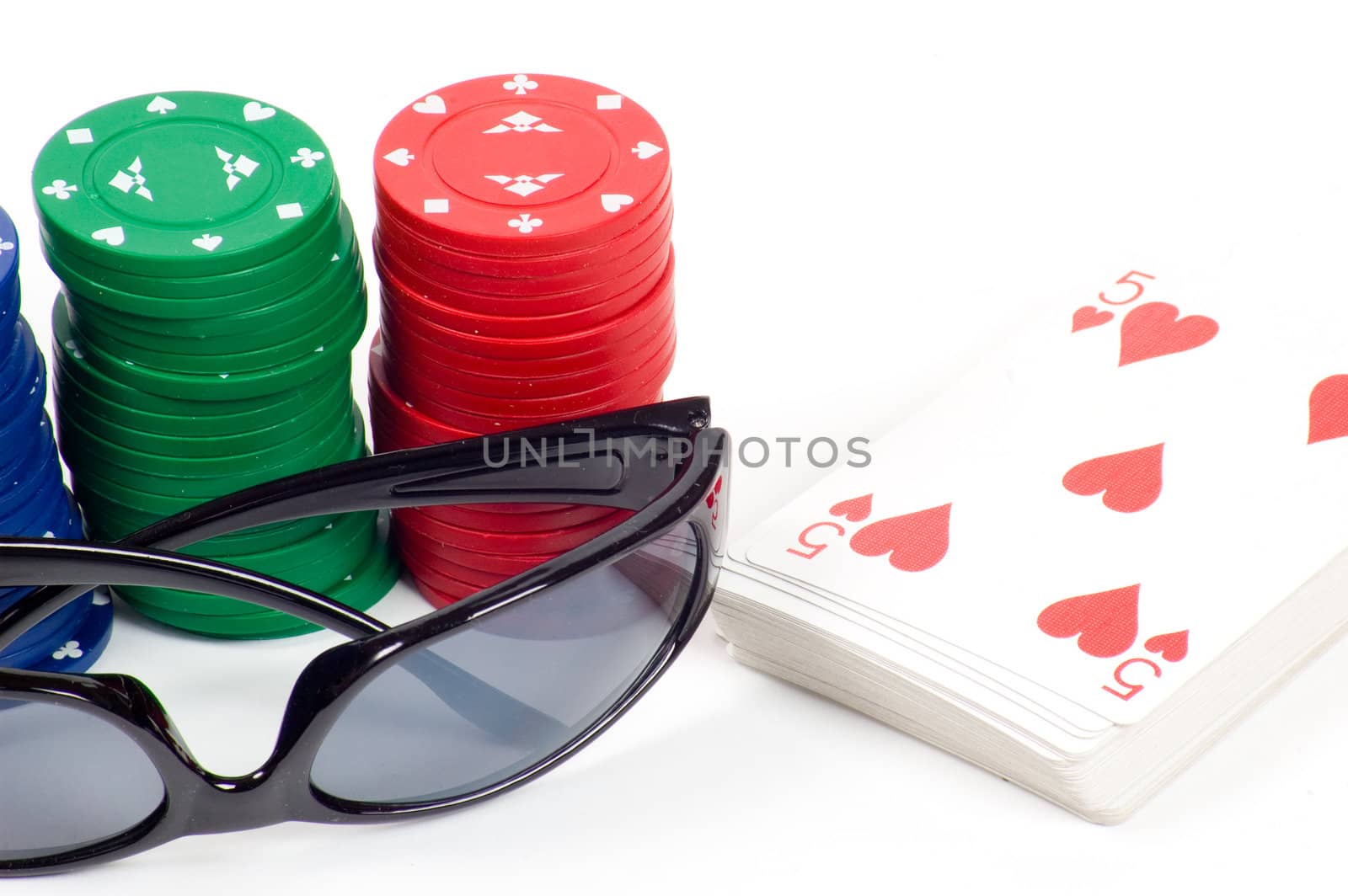 a deck of cards and casino chips isolated on white