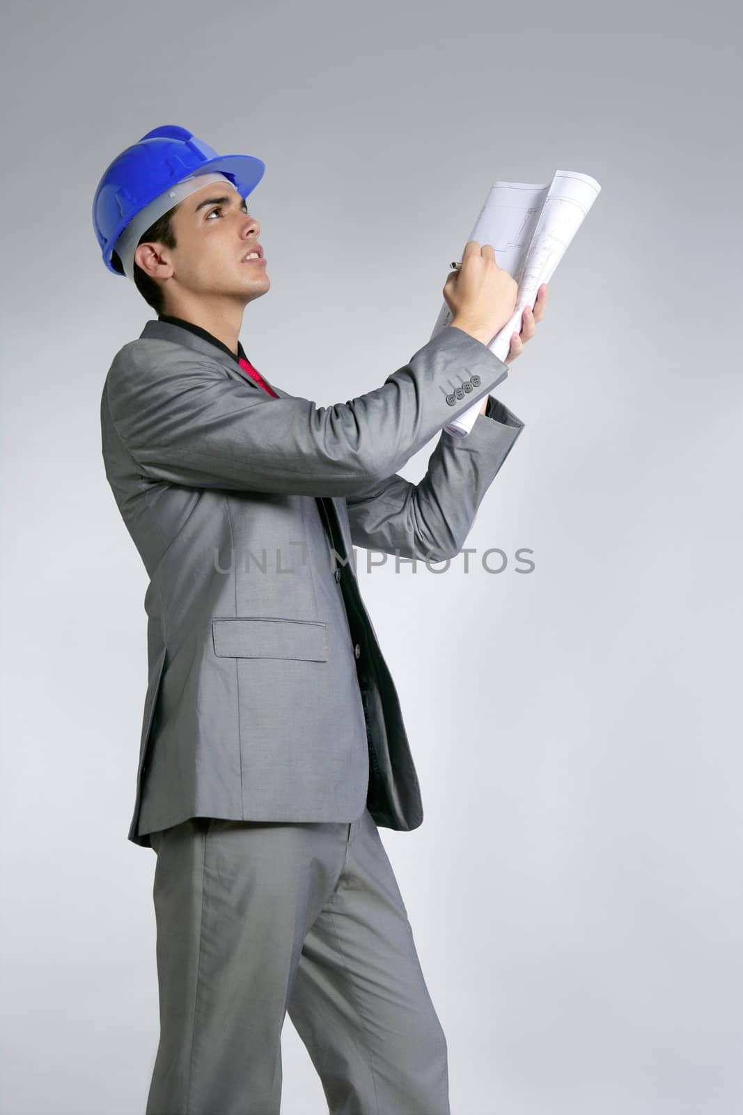 Architect engineer with blue hardhat and suit isolated on gray