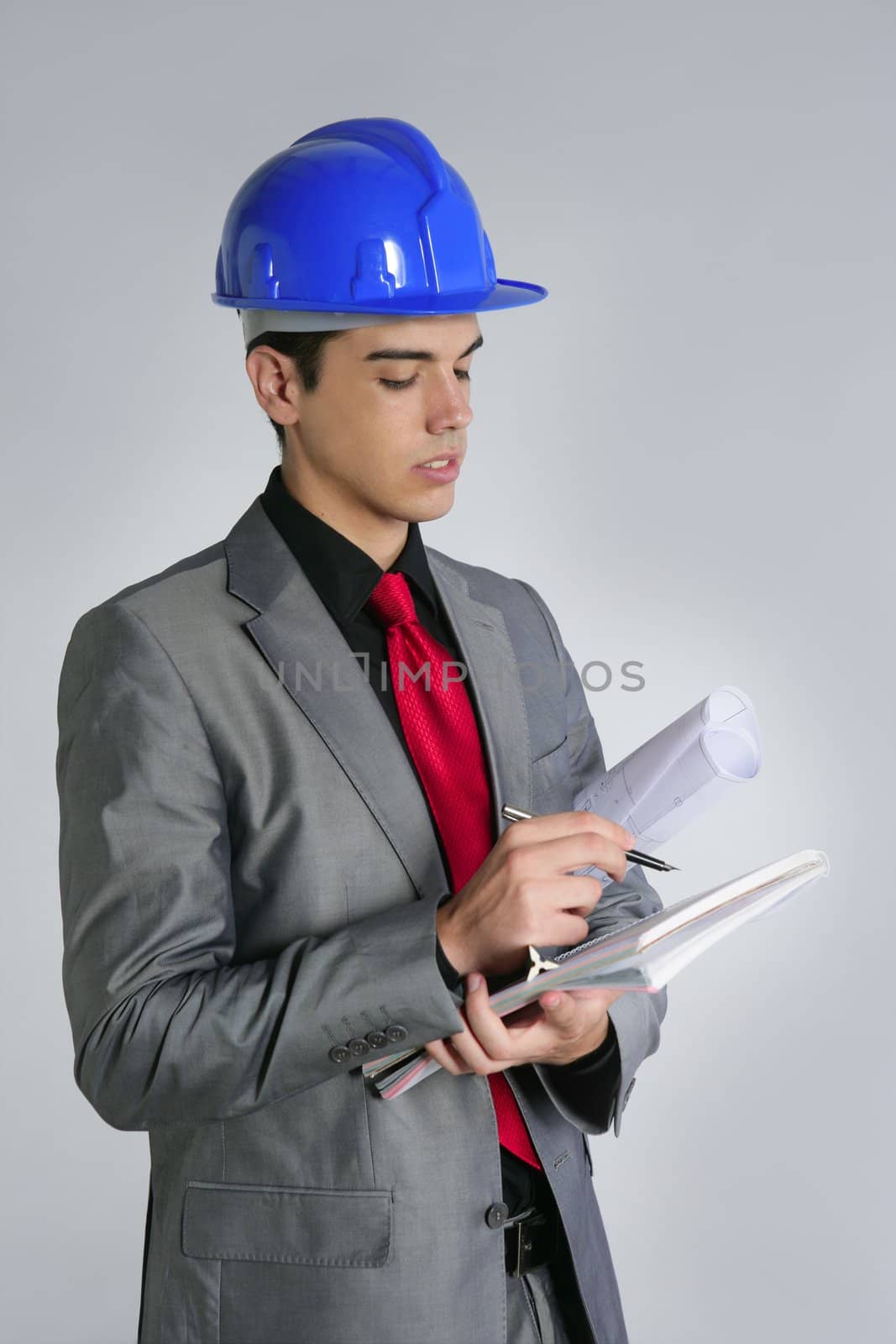 Architect engineer with blue hardhat and suit isolated on gray