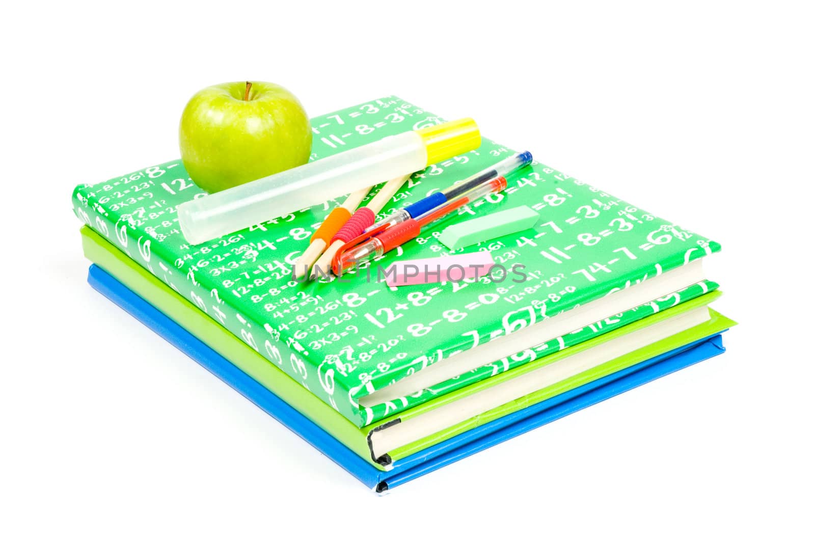 stack of books with school supply and green apple on white