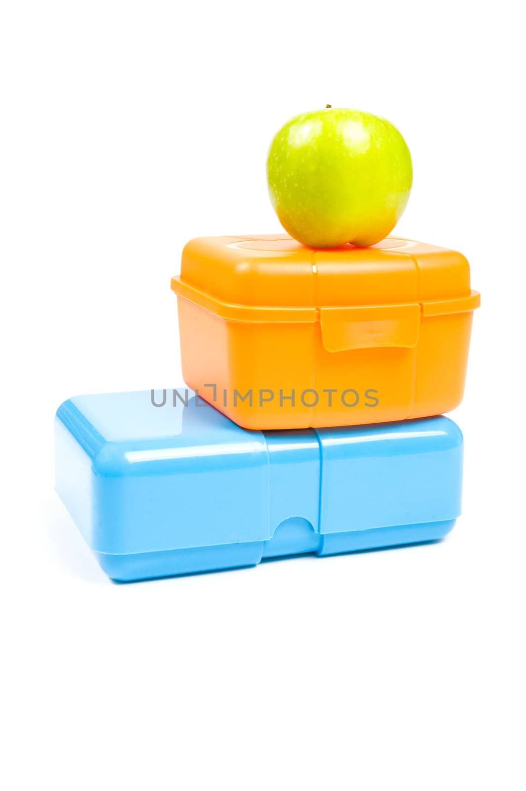 colorful lunchboxes with green apple isolated on white background