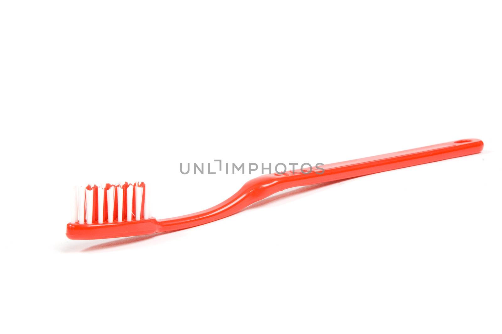 red toothbrush isolated on a white background