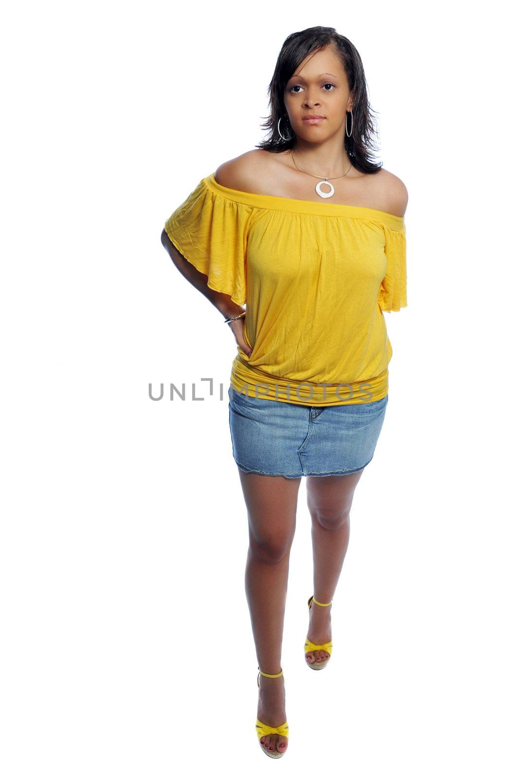 Attractive young woman in a yellow top and short skirt