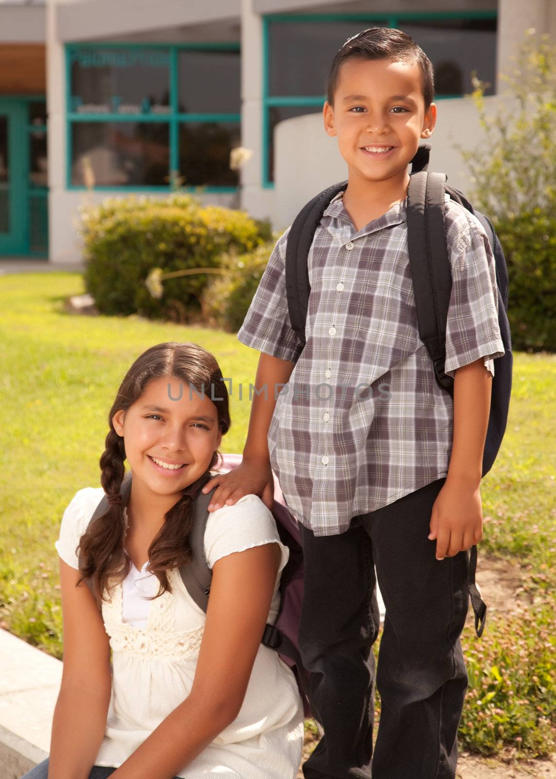 Cute Hispanic Brother and Sister Wearing Backpacks Ready for School.