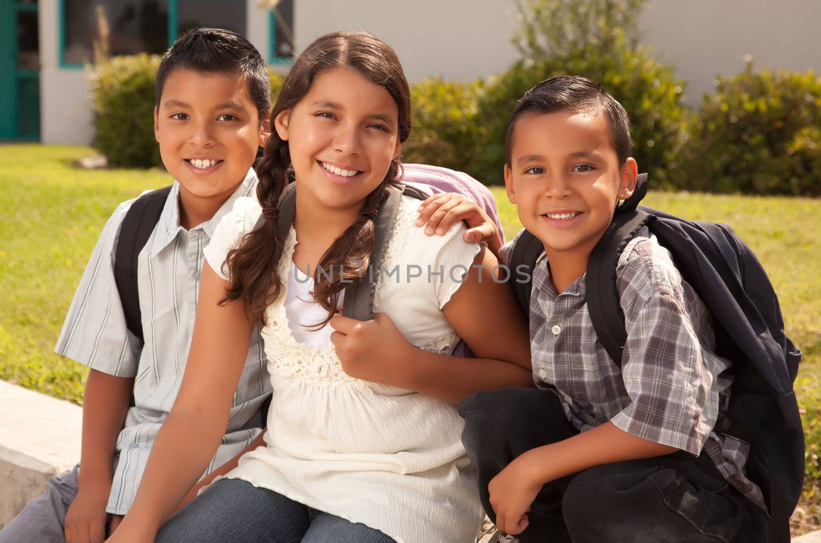 Cute Brothers and Sister Wearing Backpacks Ready for School.