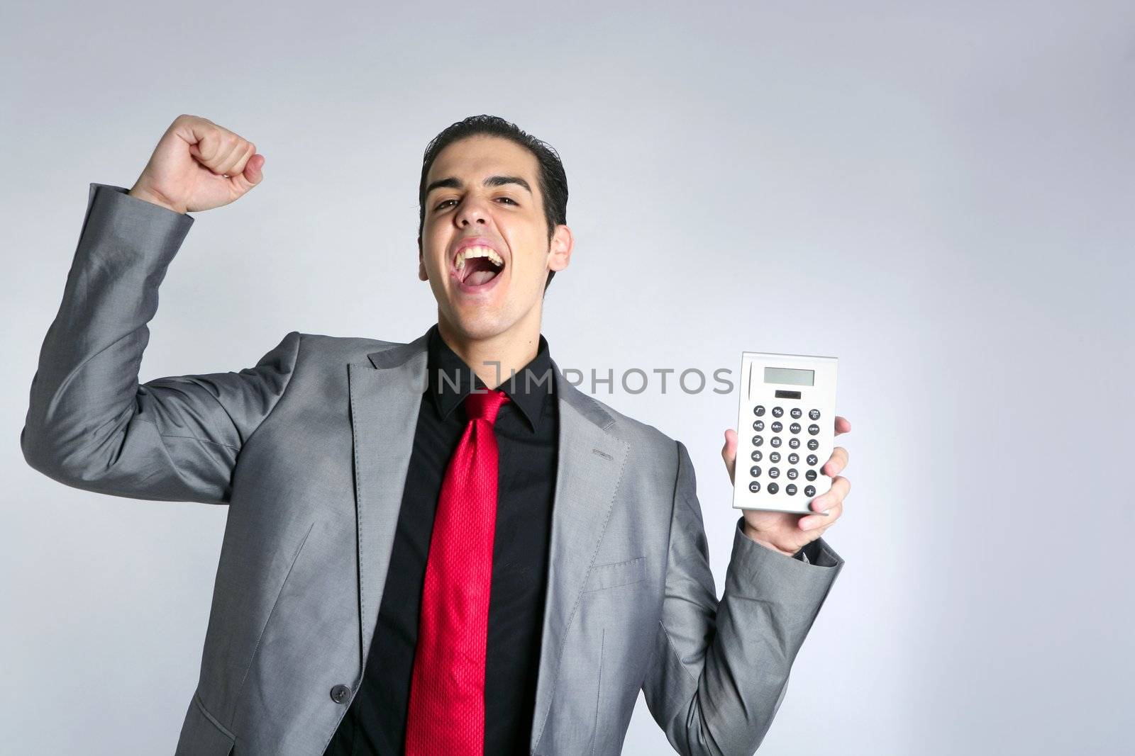 Calculator give good results to young businessman on gray background