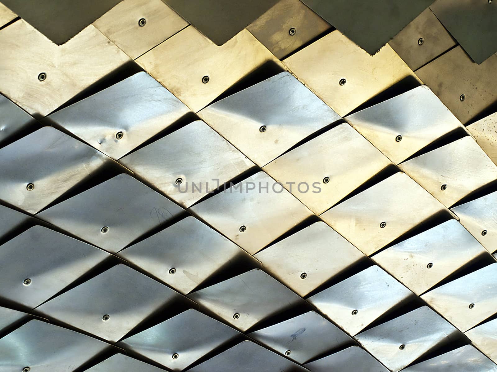 Detail of metallic scales that make up the underbelly of a dragon sculpture.