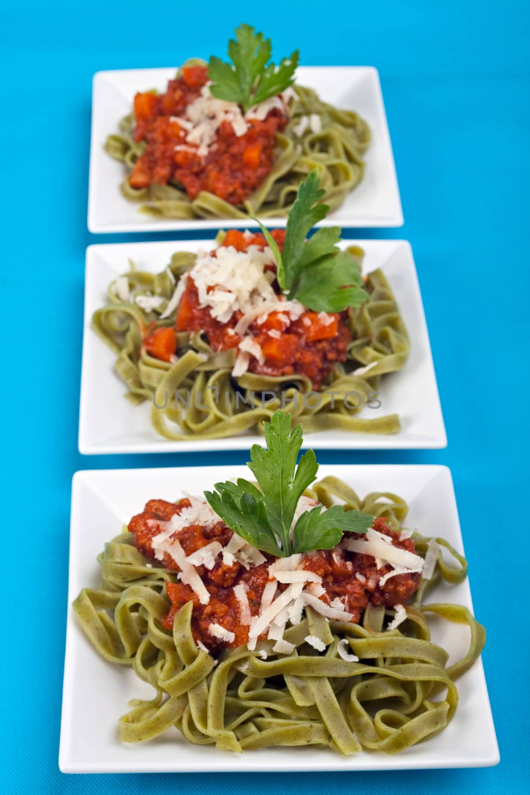 tagliatelle with sauce bolognaise in white plates