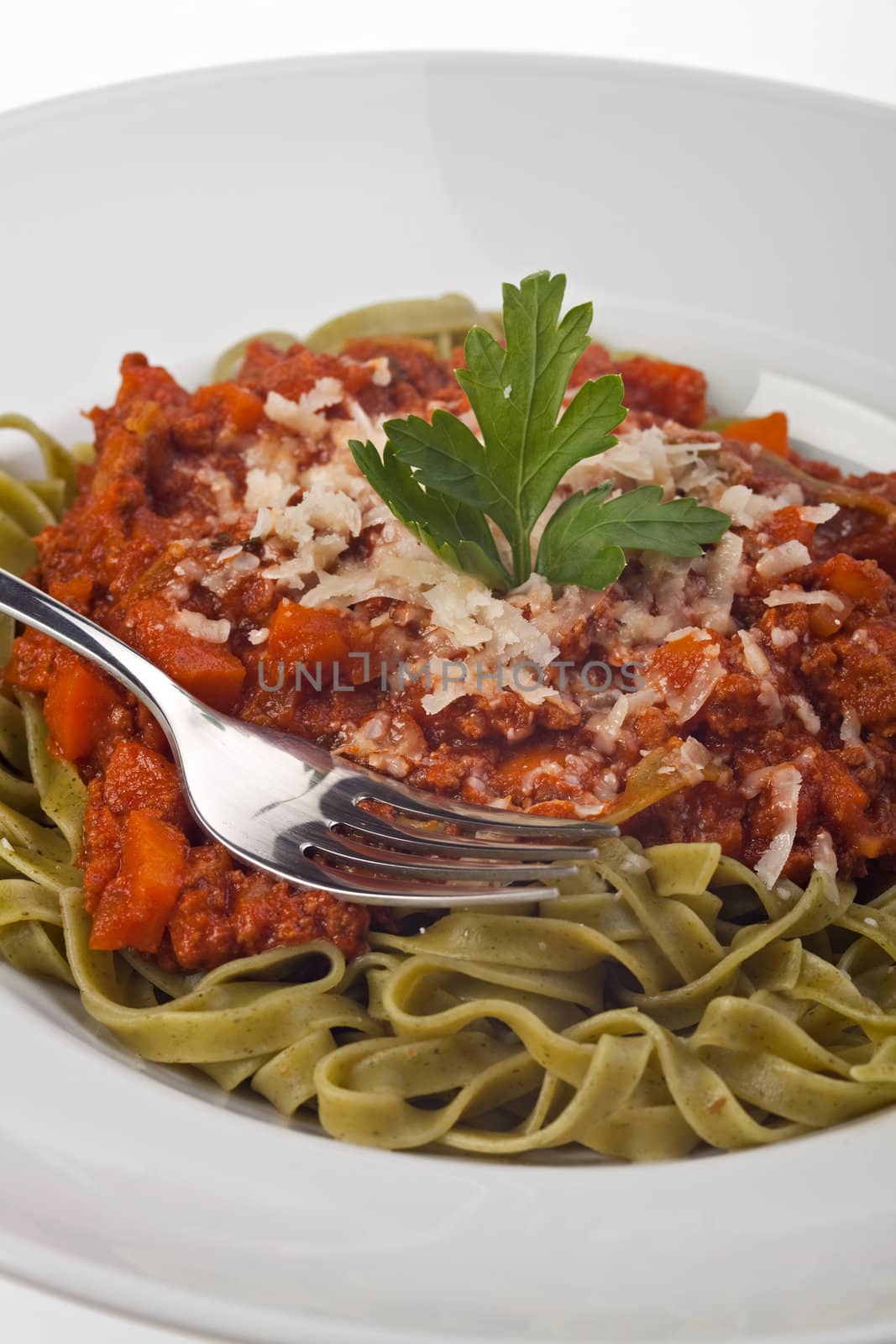 tagliatelle with sauce bolognaise in white plates