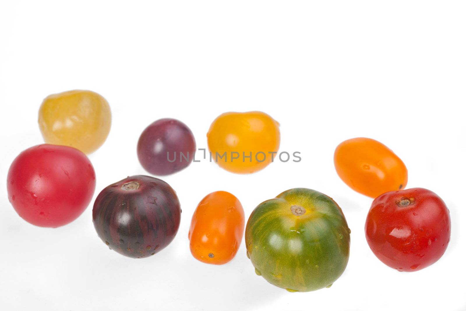 different tomatoes isolated on white background