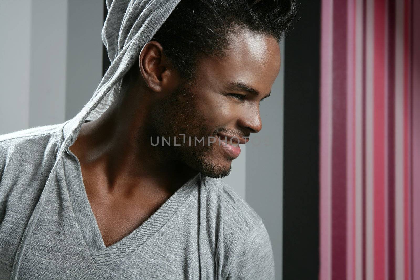 African american man with gray hood over wallpaper background
