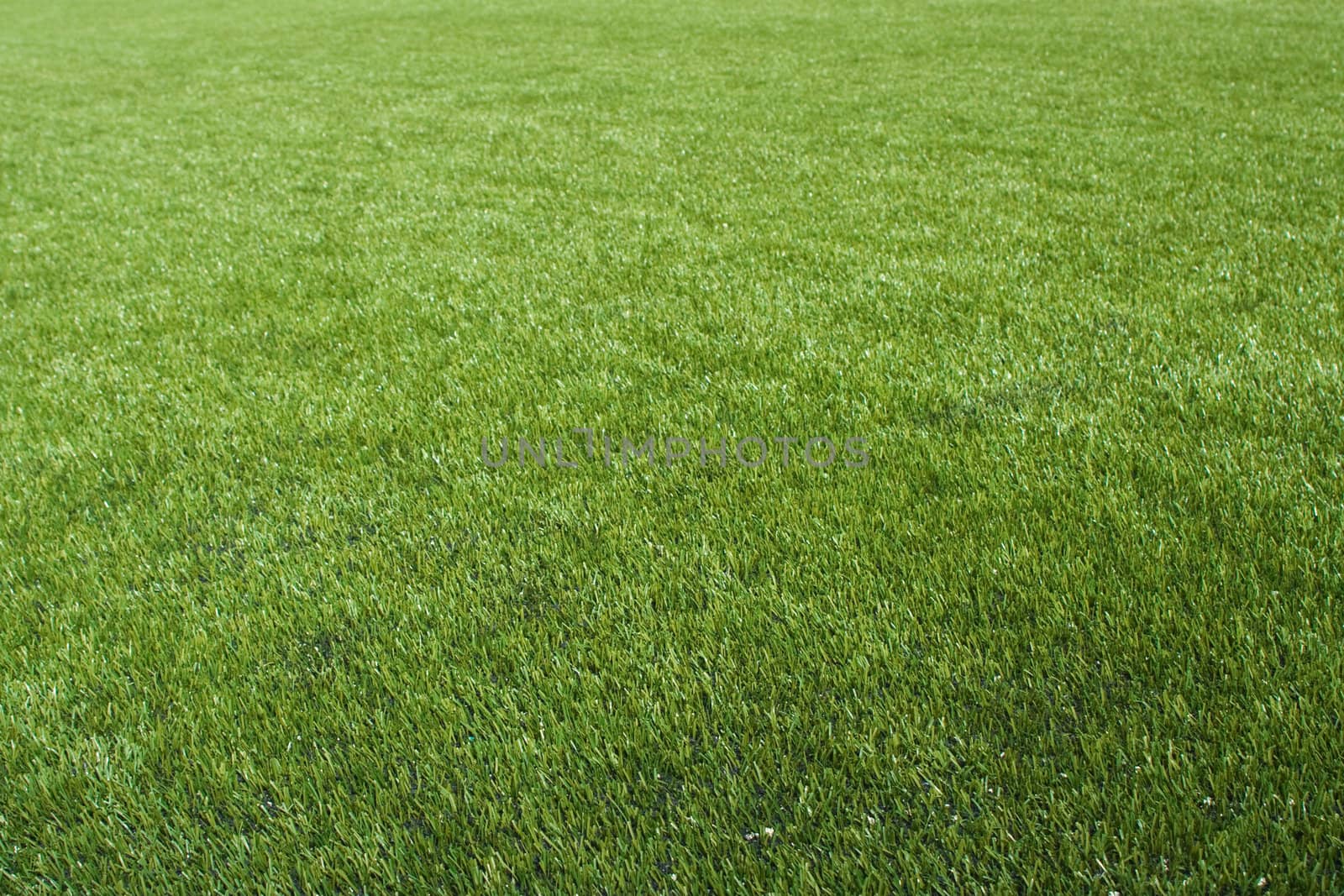 Artificial lawn on the foolball/soccer field, suitable as a background