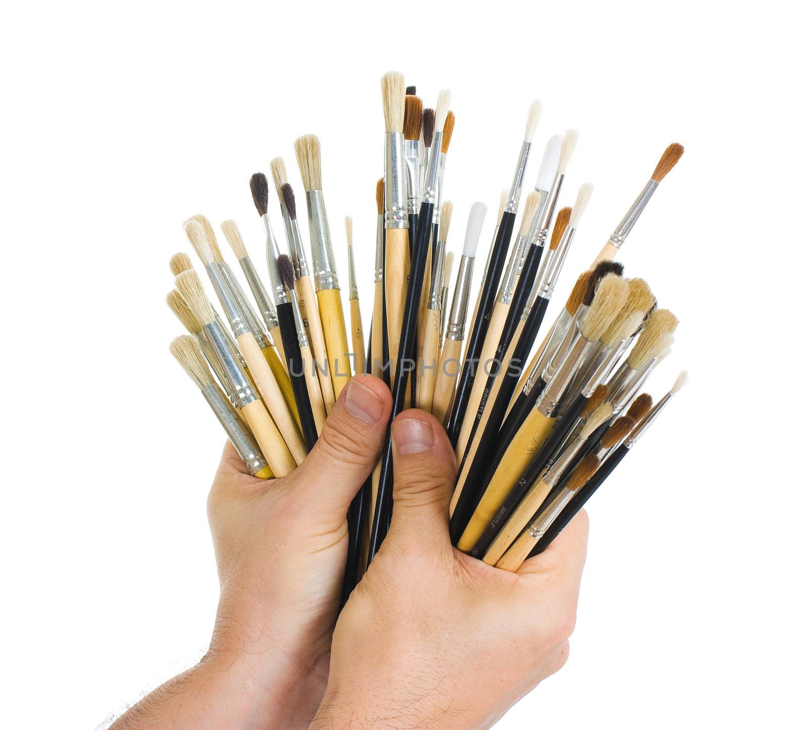 Brushes in hand isolated on white background