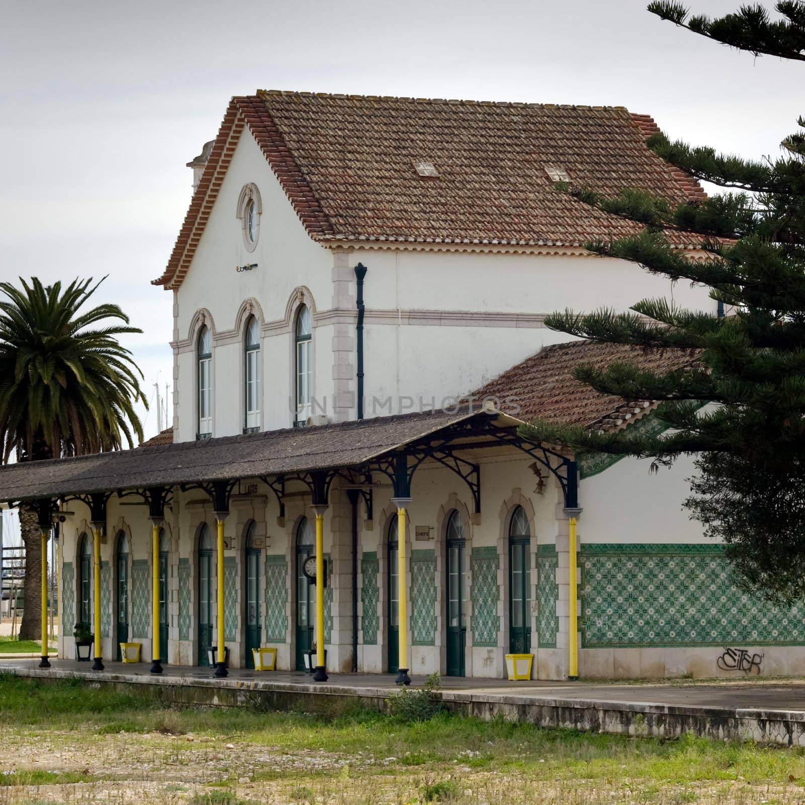 An abandoned railway station with open space in front, where railway tracks once sat.  Lagos, Portugal.