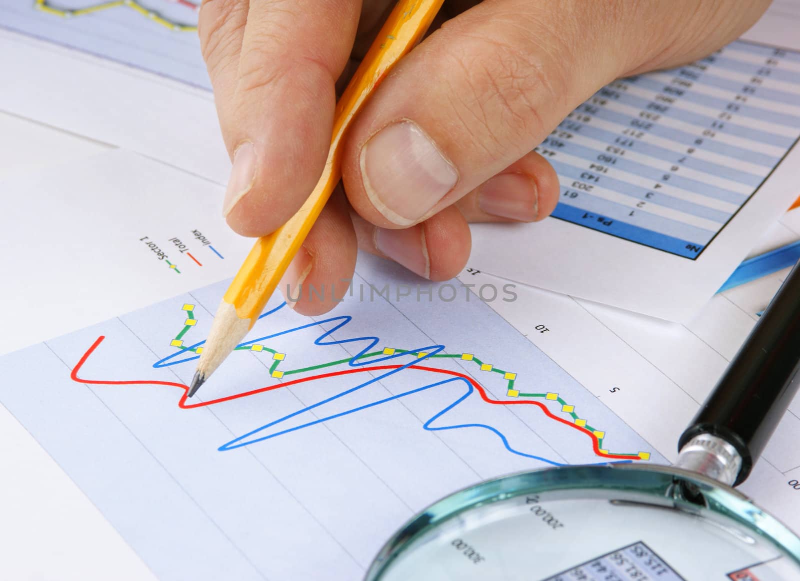 Graphs tables and documents laid on the table