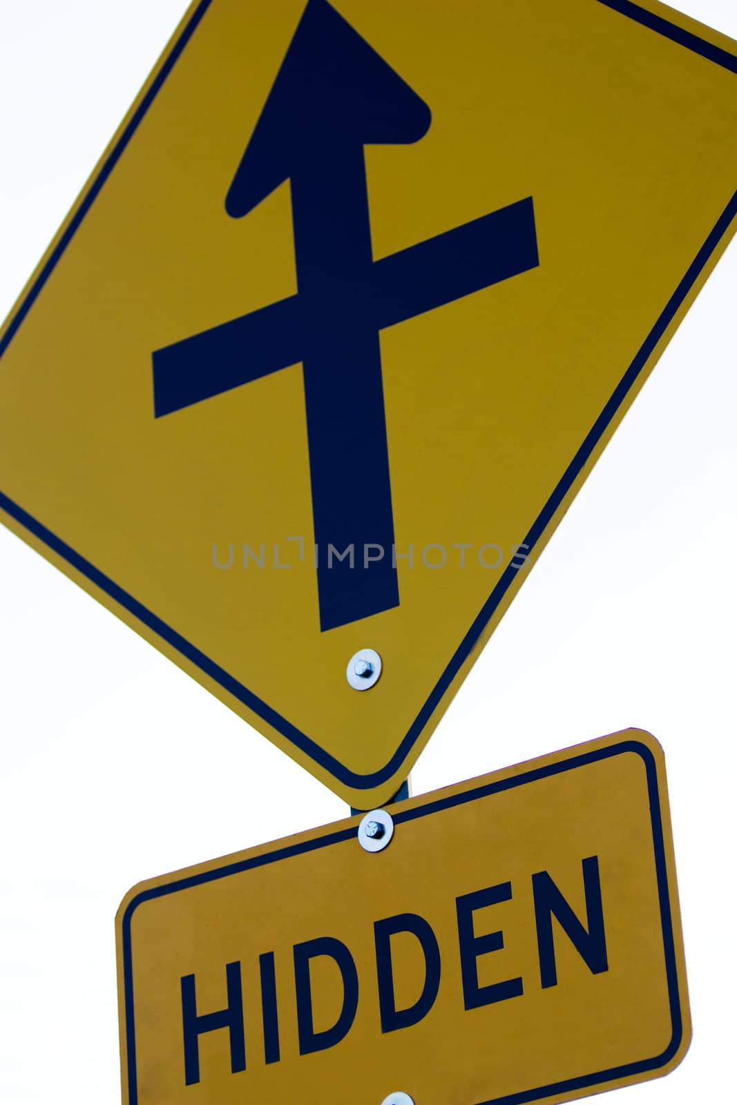 Closeup of a yellow road sign indicating a hidden road ahead, isolated on white.
