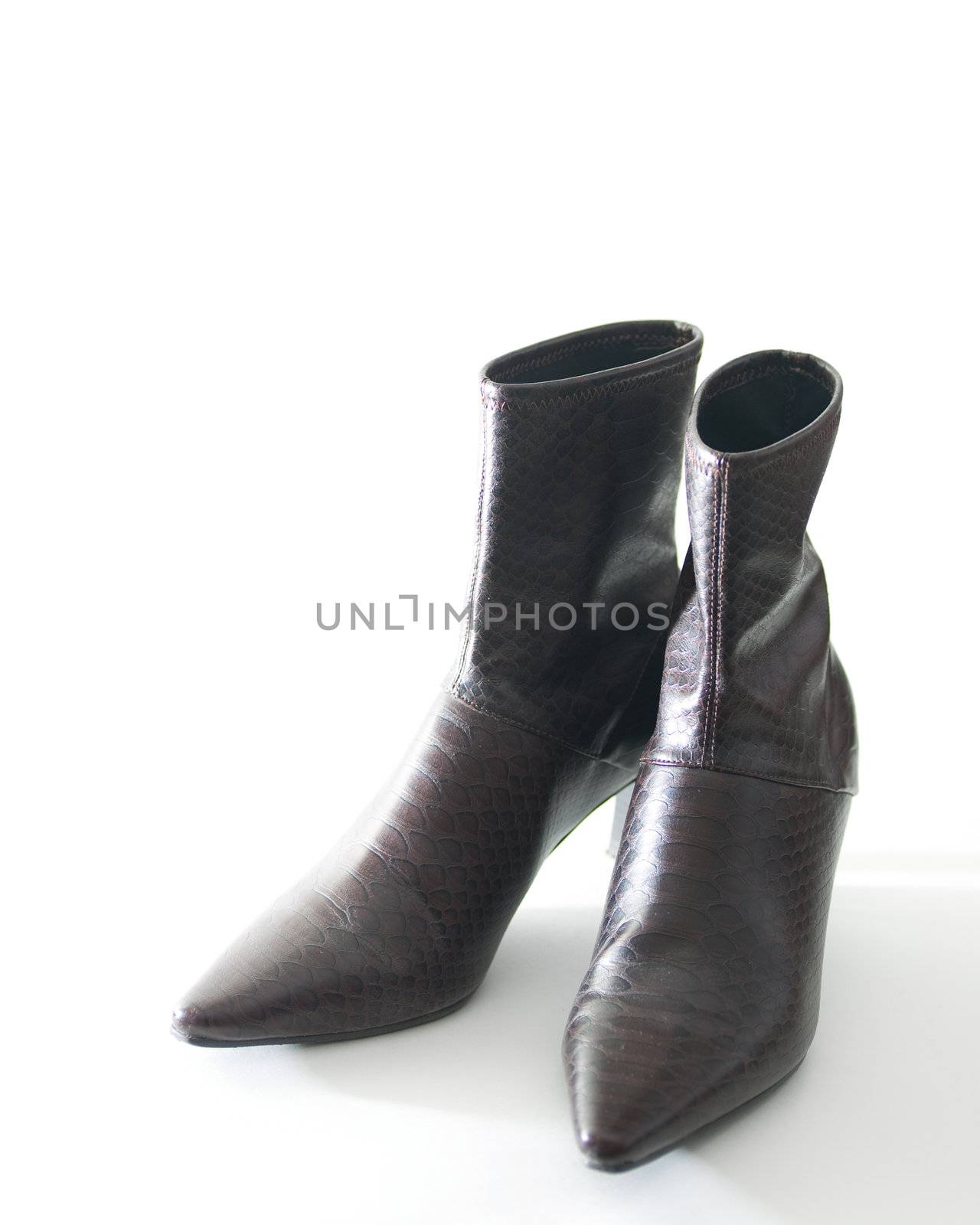 Stylish woman's high-heel boots, isolated on white.