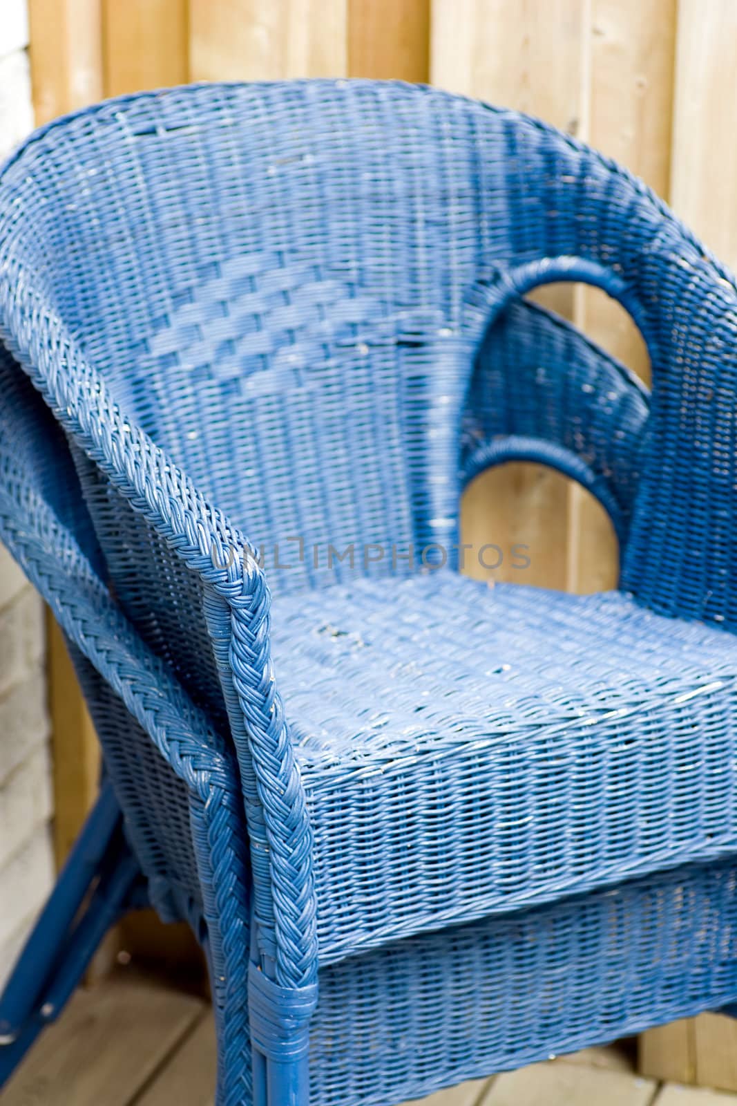 Two blue rattan outdoor deck chairs, stacked.
