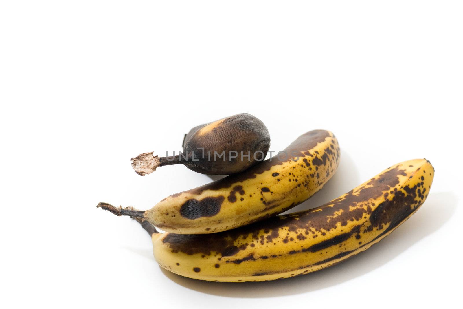 3 over-ripened bananas, isolated on white.