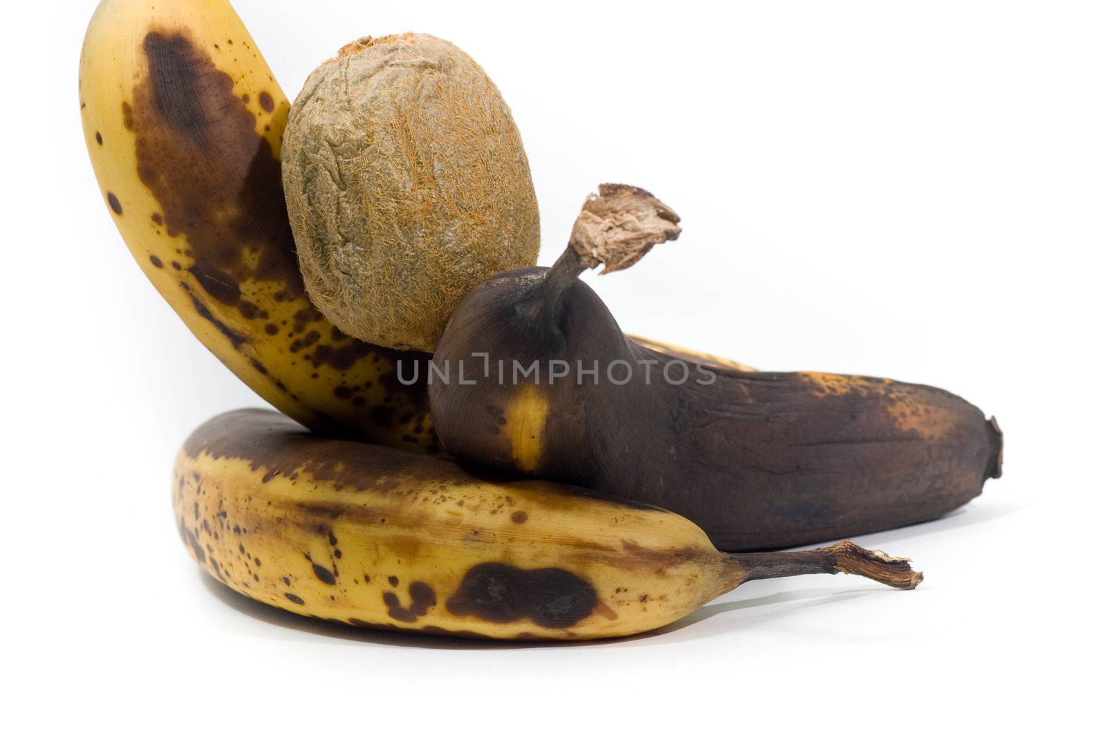 3 over-ripened bananas and a kiwi, isolated on white.