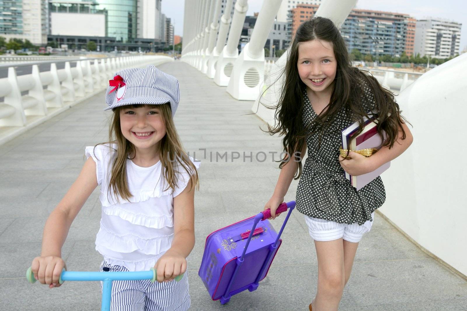 Little student girls going to school in city by lunamarina