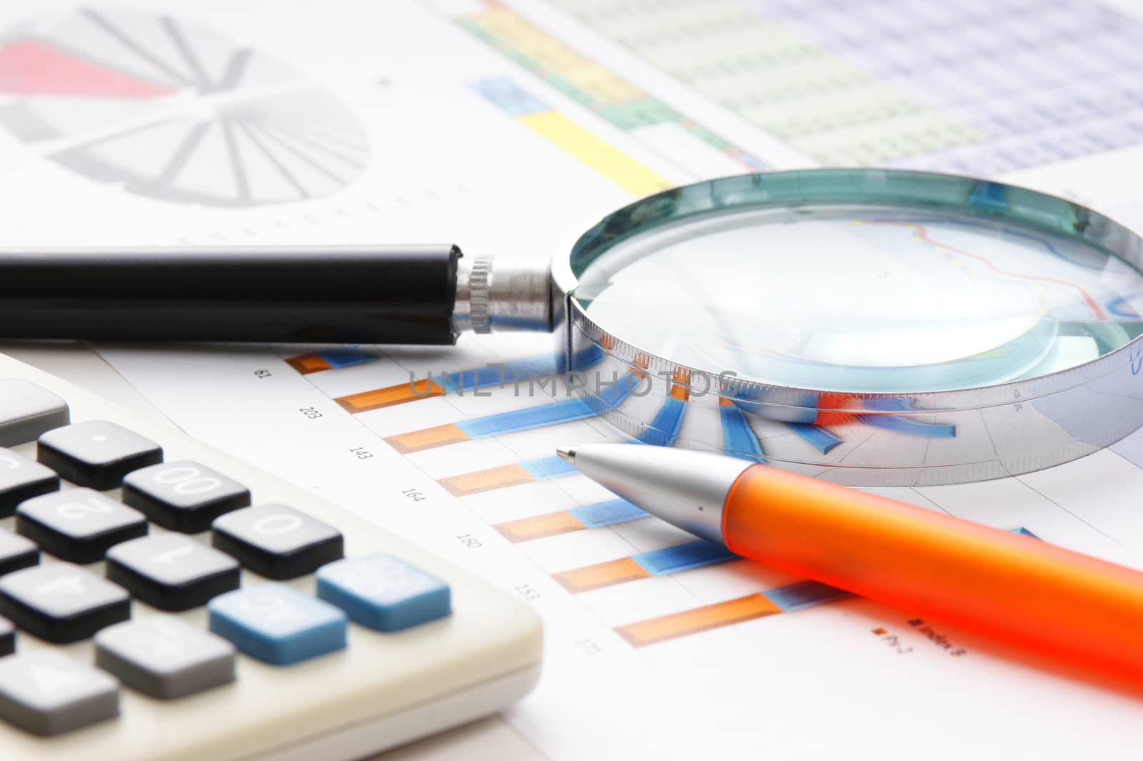 Graphs tables and documents laid on the table