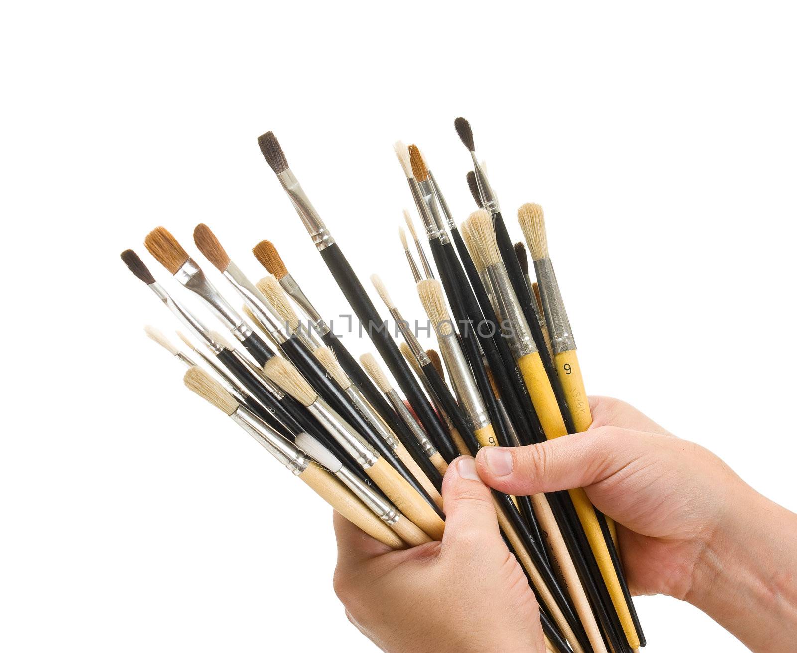 Brushes in hand isolated on white background