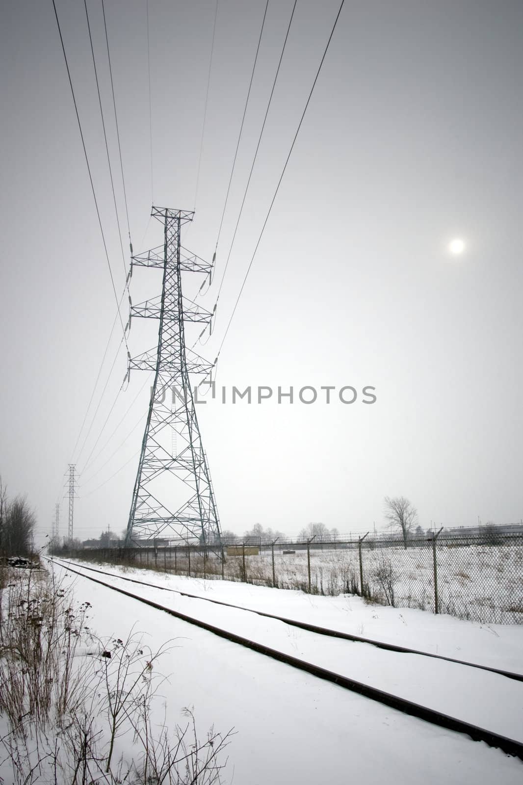 Hydro lines along train tracks in winter by woodygraphs
