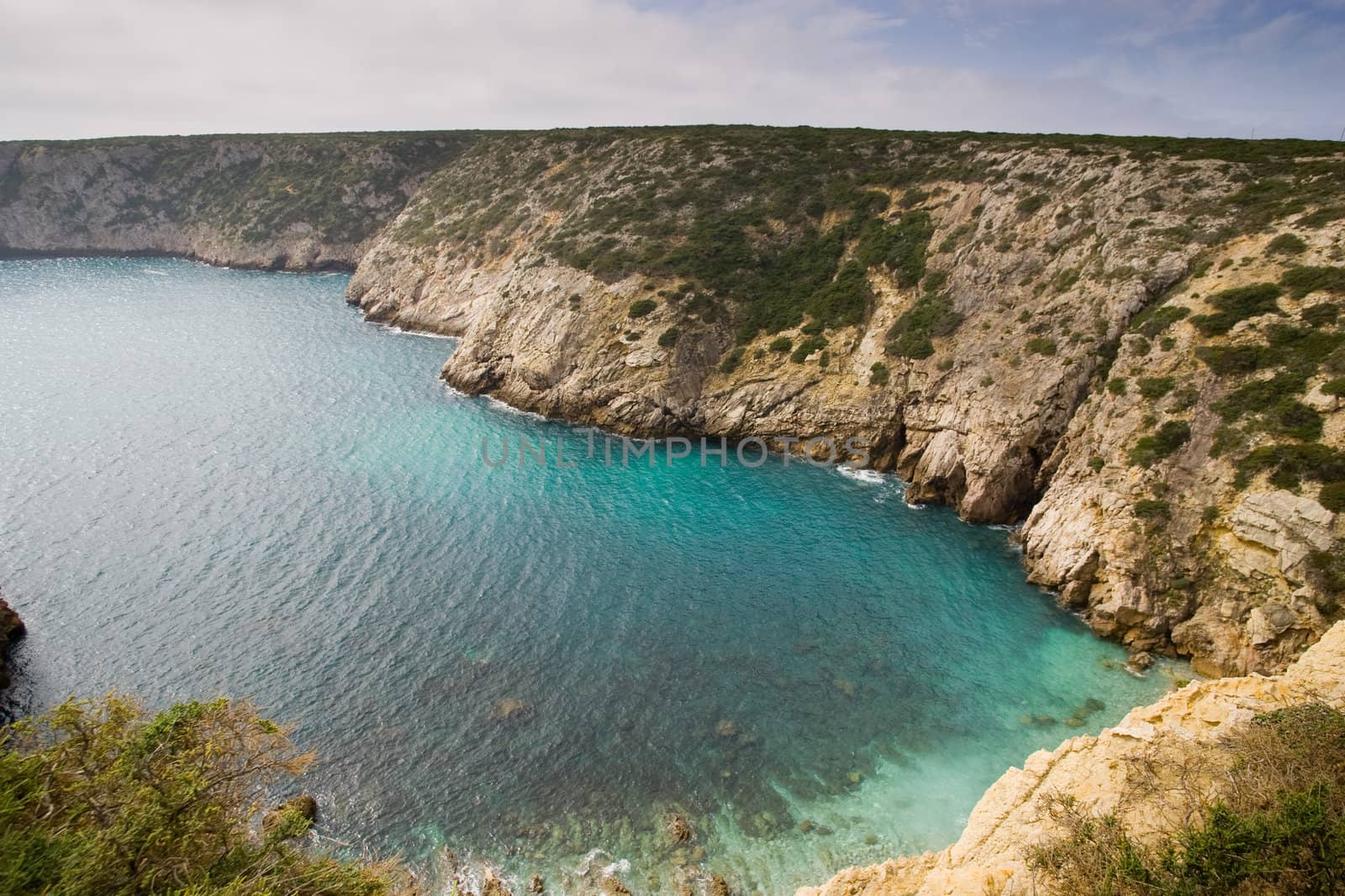 A small bay in the Algarve with clear emerald water, on the way to Cape Saint Vincent, Sagres, Portugal.