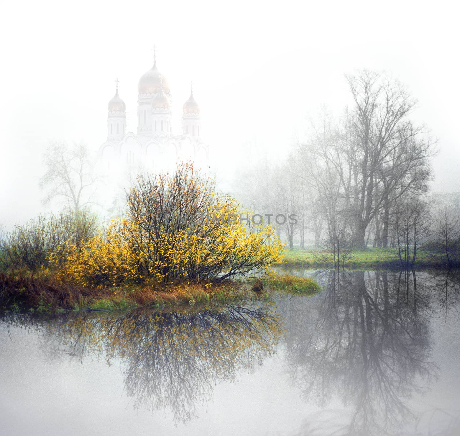 Church in the fog on the river