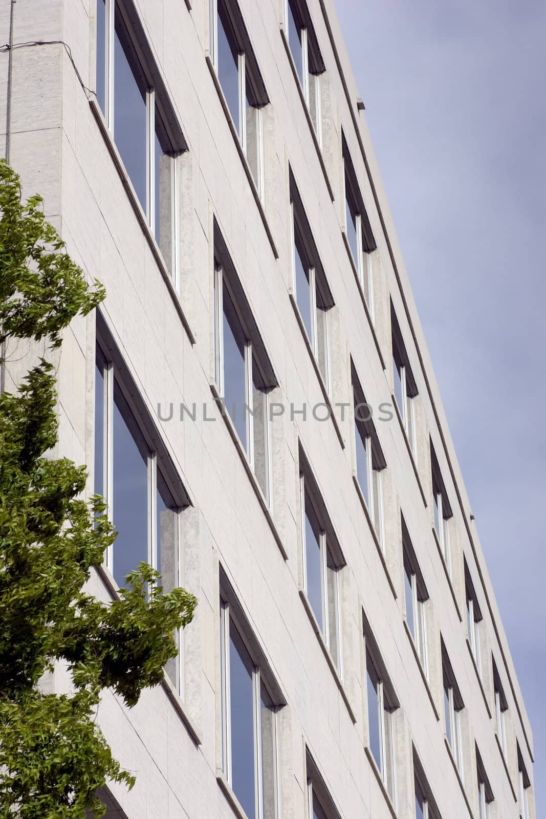 An angled view of a concrete office building.