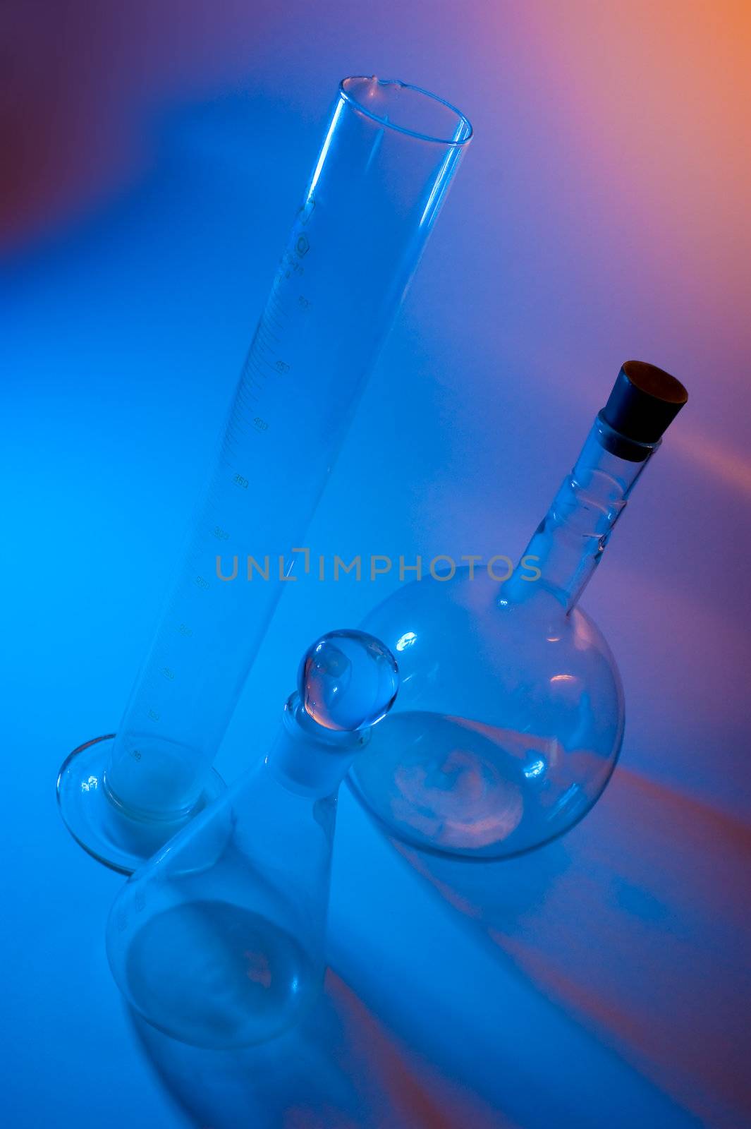 chemical glassware in multicolored lights
