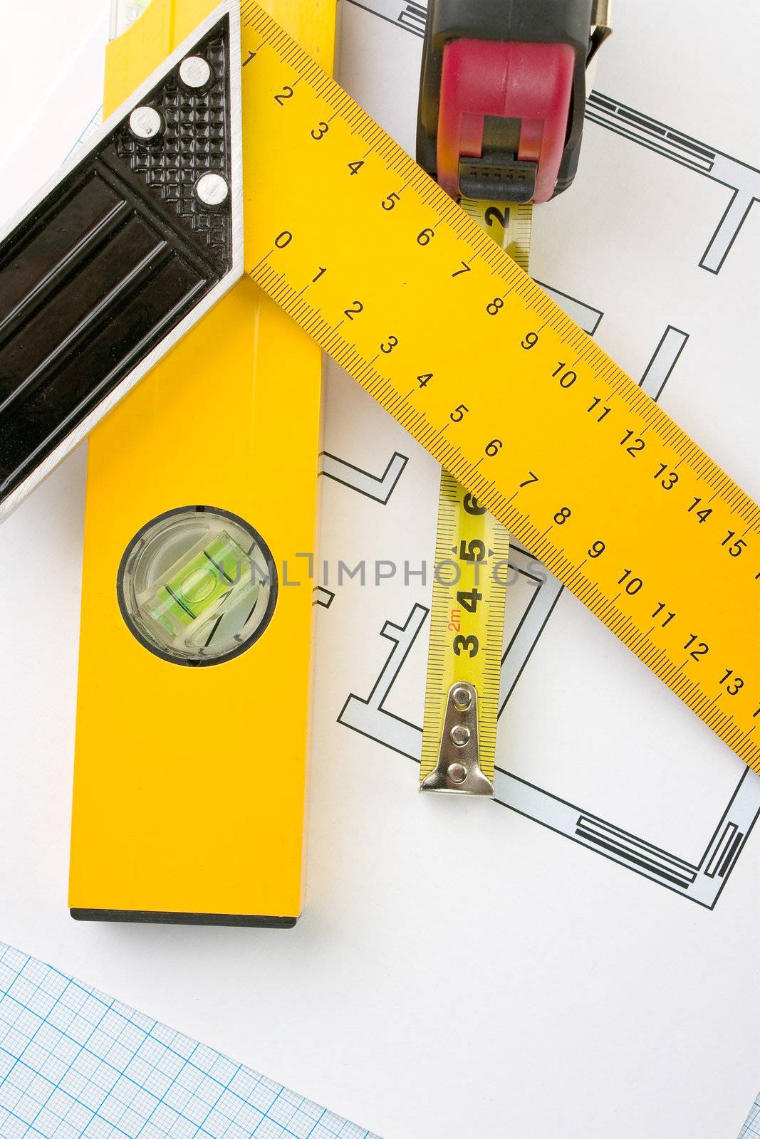 drawing at home with construction tools on a background of graph paper