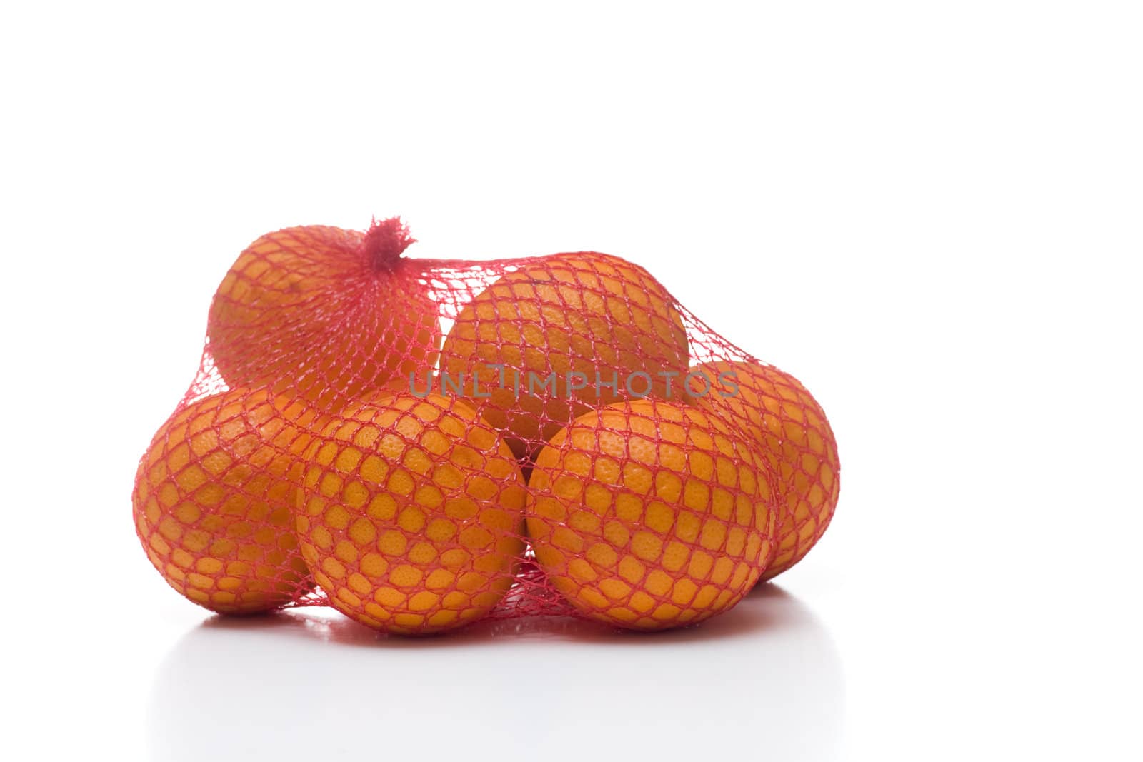 A bunch of oranges packaged in red netting, isolated on white.