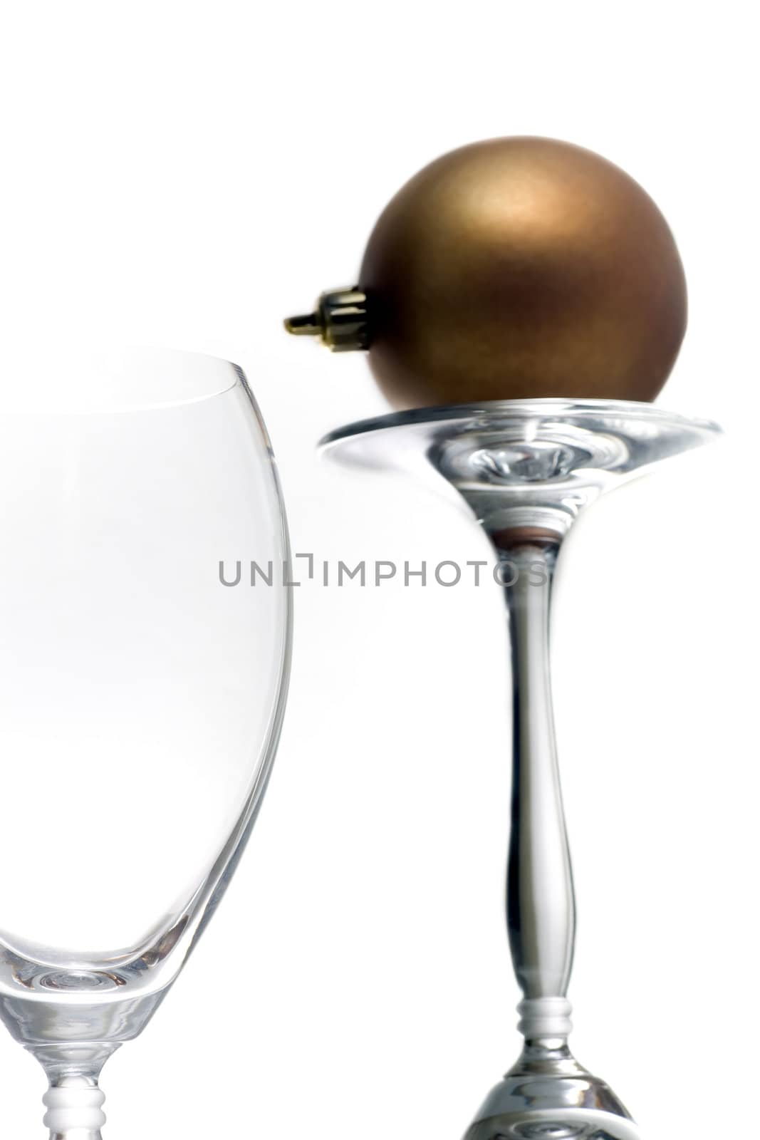 Champagne glasses with a single christmas ornament, isolated on white.
