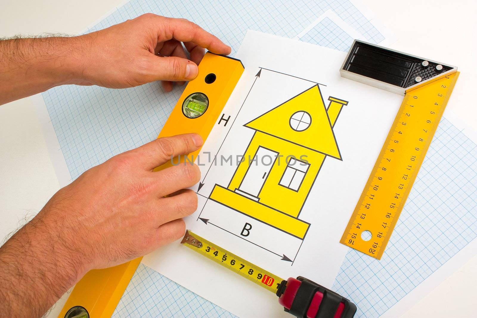 drawing at home with construction tools on a background of graph paper