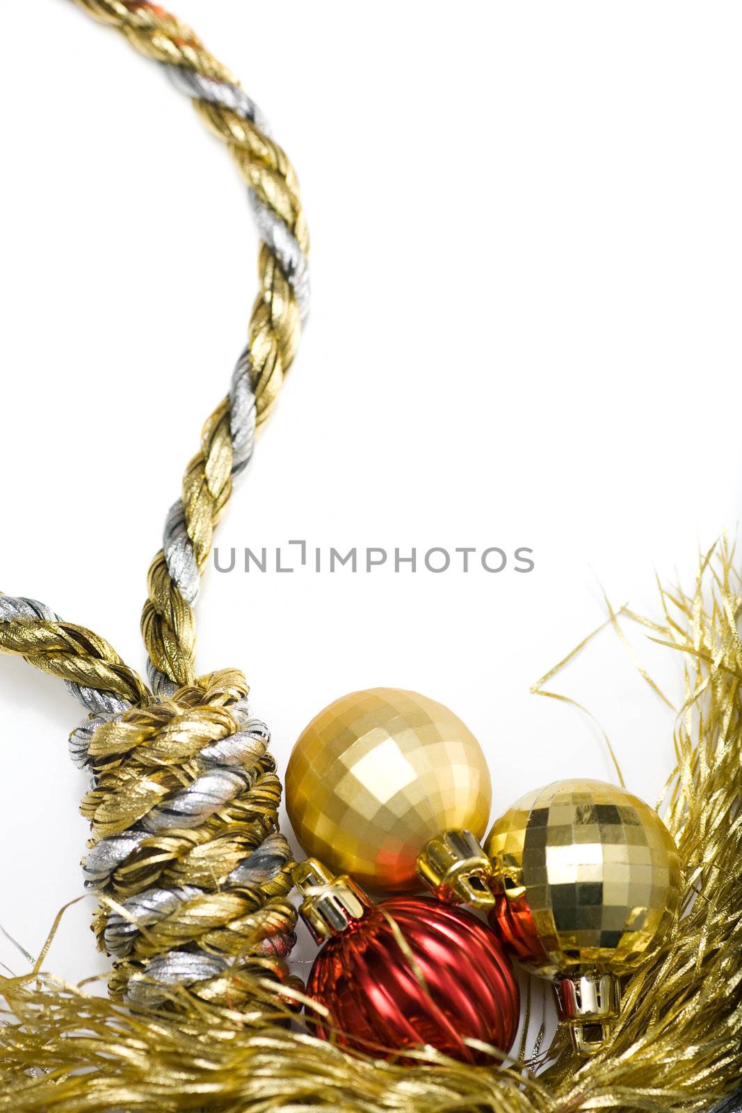 Noose made out of christmas rope, with baubles in the background, isolated on white.
